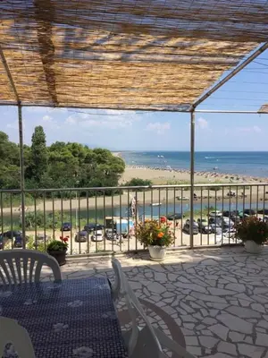 a patio with a view of a beach and the ocean at Blue Dream in Ulcinj