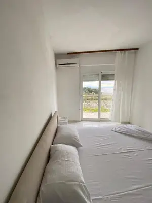 a large bed in a room with a window at Blue Dream in Ulcinj