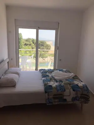 a bedroom with a bed and a view of a patio at Blue Dream in Ulcinj