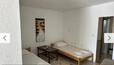 a small room with a bed and a table at Blue Dream in Ulcinj