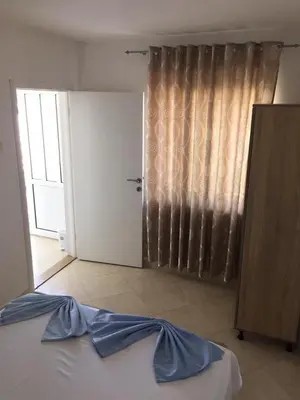 a bedroom with a bed and a door with a curtain at Blue Dream in Ulcinj