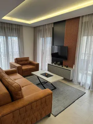 a living room with a couch and a flat screen tv at Apartman ANNA ATINA Budva in Budva