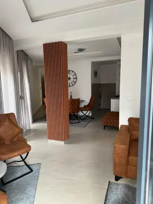 a living room with a column in the middle at Apartman ANNA ATINA Budva in Budva