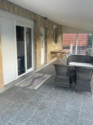 a patio with a table and chairs and a table at Njegusi-Cetinje in Njeguši