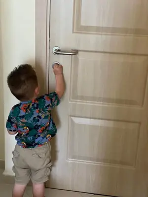 a young boy is standing in front of a door at Apartments Pericic LUX in Sutomore