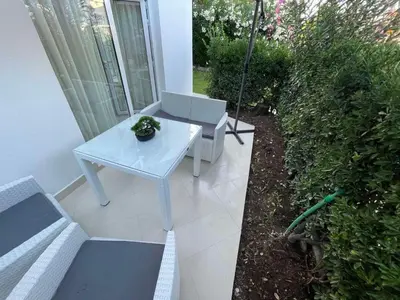 a white table and chairs on a patio at Apartments Pericic LUX in Sutomore