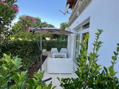 a patio with an umbrella and a table and chair at Apartments Pericic LUX in Sutomore