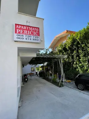 a parking garage with a sign on the side of a building at Apartments Pericic LUX in Sutomore
