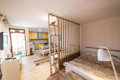 a bedroom with a bed and a staircase in it at Old Street in Podgorica