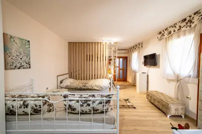 a bedroom with a bed and a couch in a room at Old Street in Podgorica