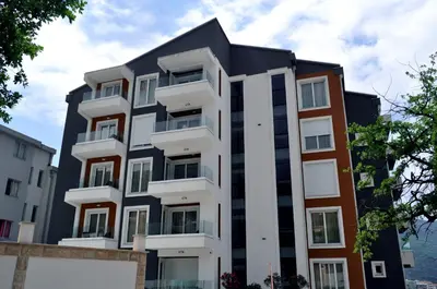 an apartment building with a black and white facade at New Chill and Go Apartments in Budva
