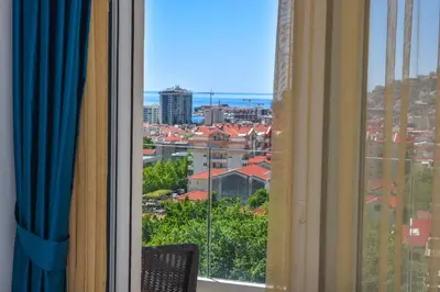a window with a view of a city at New Chill and Go Apartments in Budva