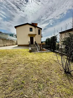 a building in a yard with a grass field at Villa Sun in Kotor