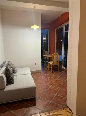 a living room with a couch and a table at Themis Apartment in Kotor
