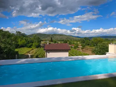 a swimming pool with a view of the mountains at Auto camp Matica in Podgorica