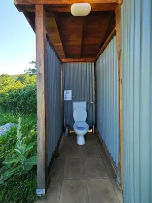 a bathroom with a toilet inside of a building at Auto camp Matica in Podgorica