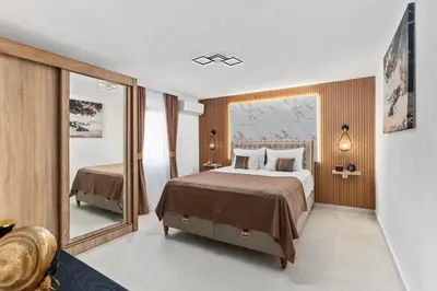 a bedroom with a large bed and a large mirror at Apartment Petar 1 in Kotor