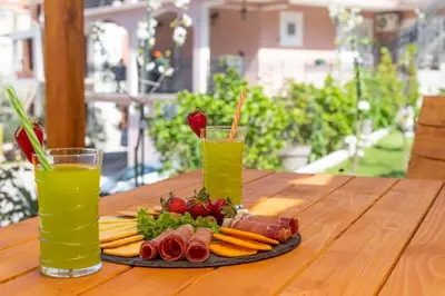 a plate of food on a table with two drinks at Apartment Petar 1 in Kotor