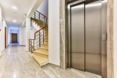 a metal elevator in a hallway with stairs at Studio Lemar in Budva