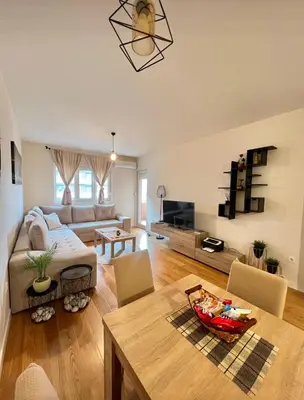 a living room with a couch and a table at White Homes - Central Point in Podgorica