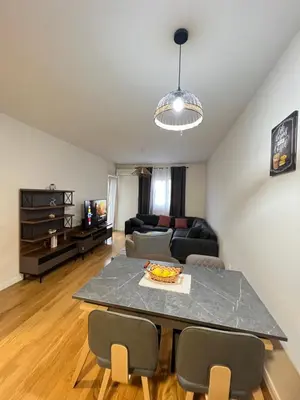a living room with a table and a couch at White Homes - Central Point in Podgorica