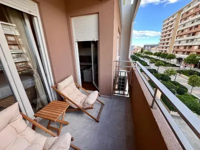 a balcony with two chairs and a table at White Homes - Central Point in Podgorica