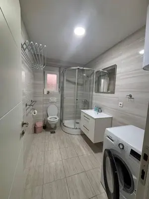 a bathroom with a shower and a washing machine at Stan-apartman, Apartment, квартира in Bar