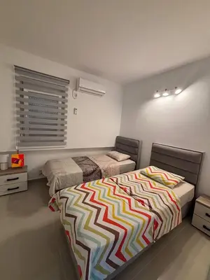 a bedroom with two beds and a window at Stan-apartman, Apartment, квартира in Bar