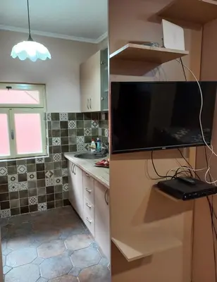a kitchen with a flat screen tv and a counter top at Iva apartment in Kotor