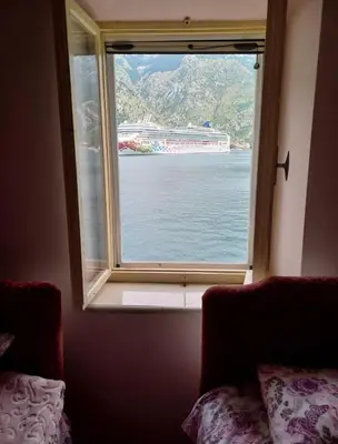 a window in a room with a view of the water at Iva apartment in Kotor