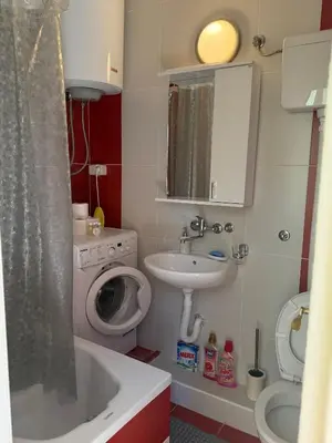 a small bathroom with a sink and a toilet at Iva apartment in Kotor