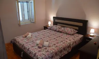 a bedroom with a bed with two pillows on it at Iva apartment in Kotor