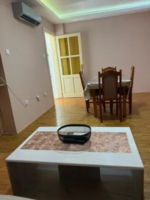 a living room with a table with a phone on it at Iva apartment in Kotor