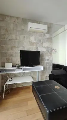 a living room with a desk with a tv and a couch at Apartment Pržno in Pržno