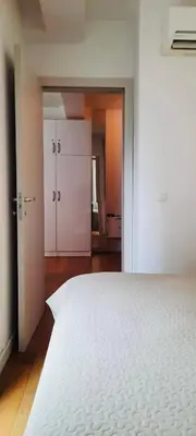 a bedroom with a large white bed and a closet at Apartment Pržno in Pržno