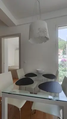 a dining room with a glass table and chairs at Apartment Pržno in Pržno