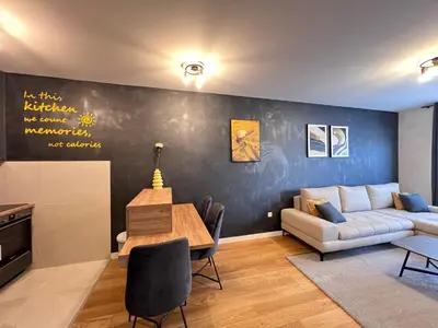 a living room with a couch and a table at White Homes 105 - Central Point in Podgorica