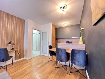 a kitchen and dining room with a table and chairs at White Homes 105 - Central Point in Podgorica