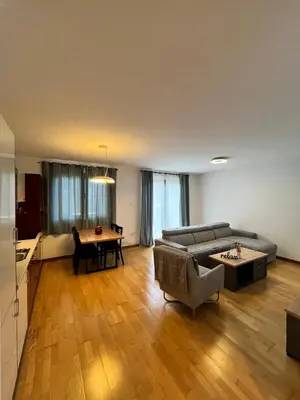 a living room with a couch and a table at Blue lagoon apartment Przno in Budva