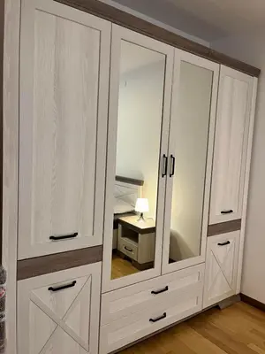 a large white cabinet with a mirror in a room at Blue lagoon apartment Przno in Budva