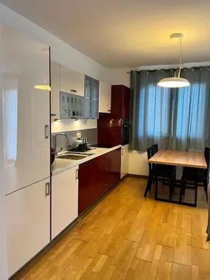 a kitchen with a table and a wooden floor at Blue lagoon apartment Przno in Budva