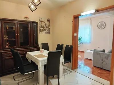 a dining room with a table and black chairs at Green Valley GV in Kotor