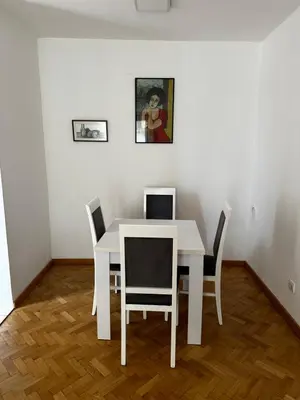 a white table and chairs in a room at City apartment with the sea view in Bar