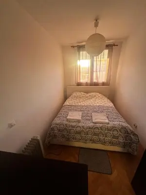 a small bedroom with a bed and a window at City apartment with the sea view in Bar