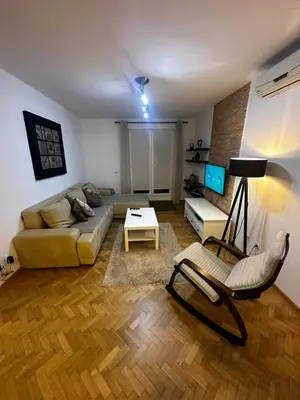 a living room with a couch and a table at City apartment with the sea view in Bar