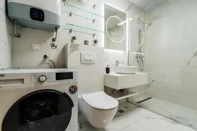 a white bathroom with a toilet and a sink at Monte Living by In Property in Ðenaši