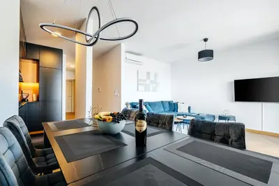 a dining room with a table with a bottle of wine at Monte Living by In Property in Ðenaši