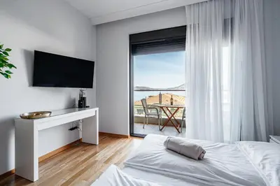 a bedroom with a bed and a view of the ocean at Przno Apartments by In Property in Pržno