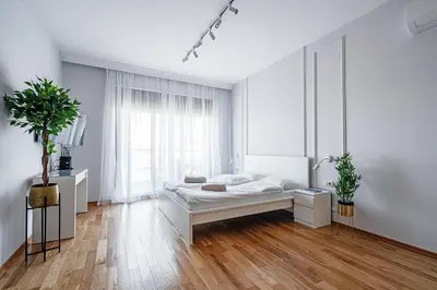 a white bedroom with a bed and a window at Przno Apartments by In Property in Pržno