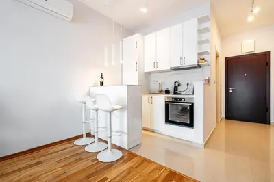 a kitchen with white cabinets and white appliances at Przno Apartments by In Property in Pržno